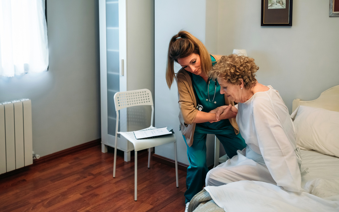 Caregiver Helping Elderly Patient 