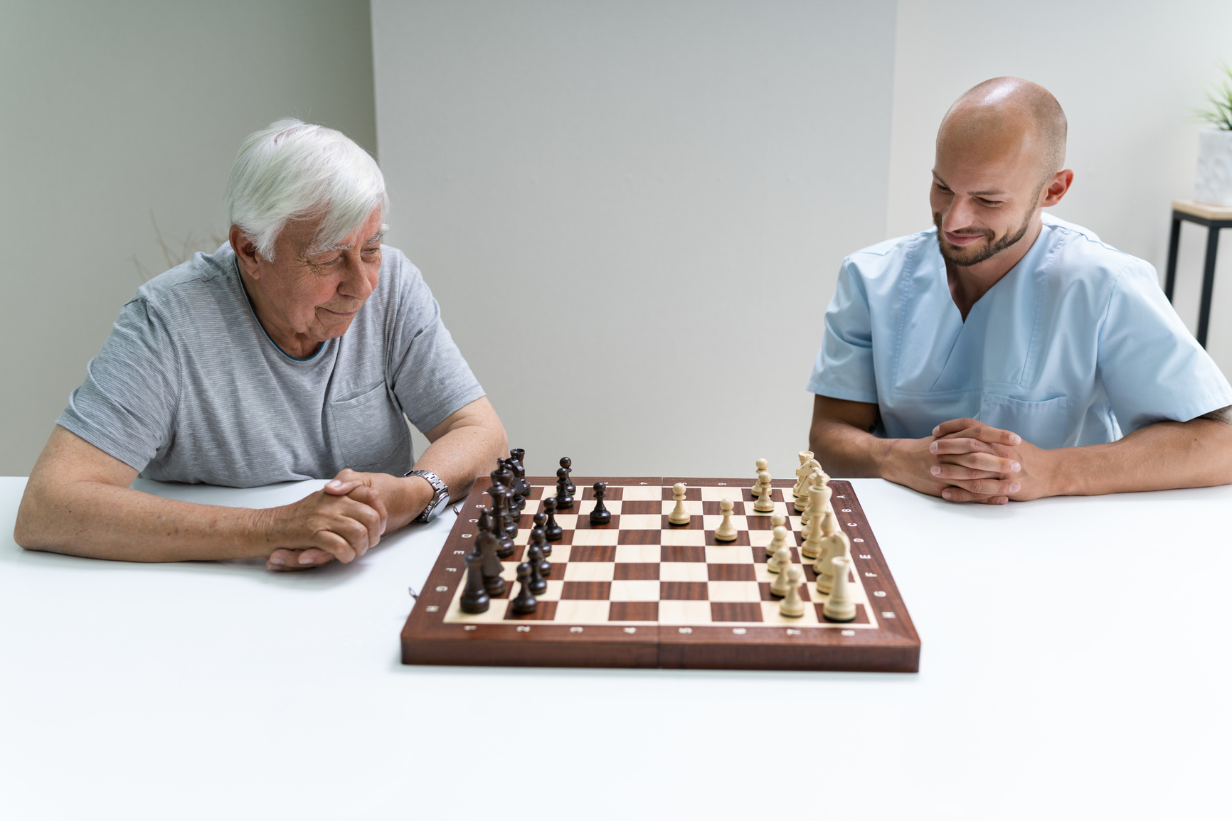 Elderly Senior Playing Chess With Caregiver